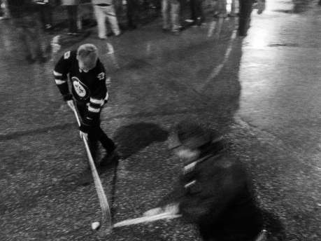 Street hockey at Portage and Main by emily elizabeth enns